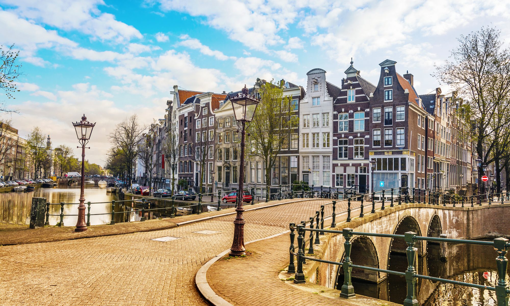 Traditional dutch old houses and bridges on canals in Amsterdam, Netherlands