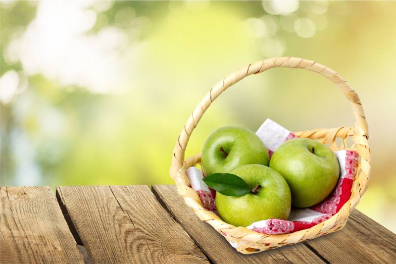 Basked with apples on a wooden table - Toronto Cider Festival